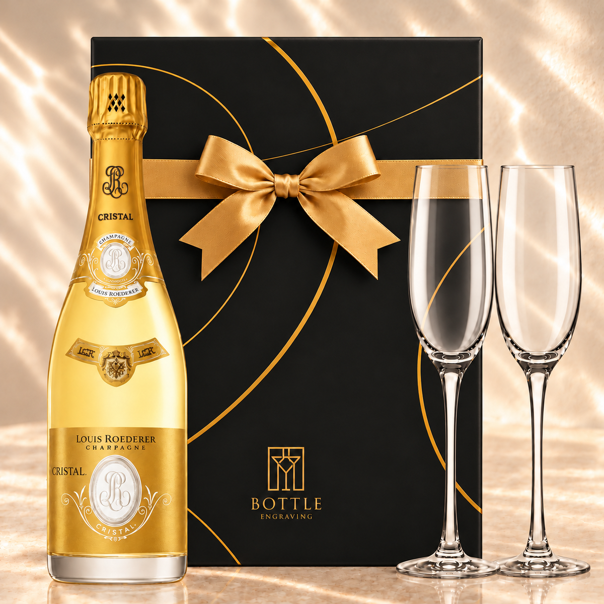 Louis Roederer Cristal Champagne gift set with two champagne flutes and a black Bottle Engraving gift box tied with a gold bow.
