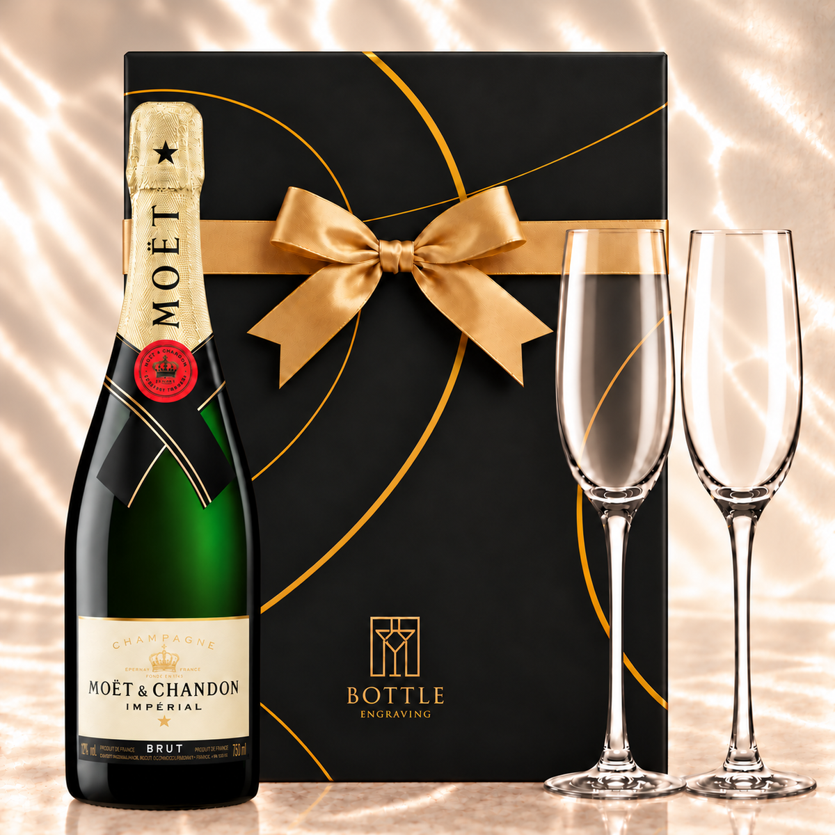 Moët & Chandon Impérial Brut Champagne gift set with two champagne flutes and a black Bottle Engraving gift box tied with a gold bow.