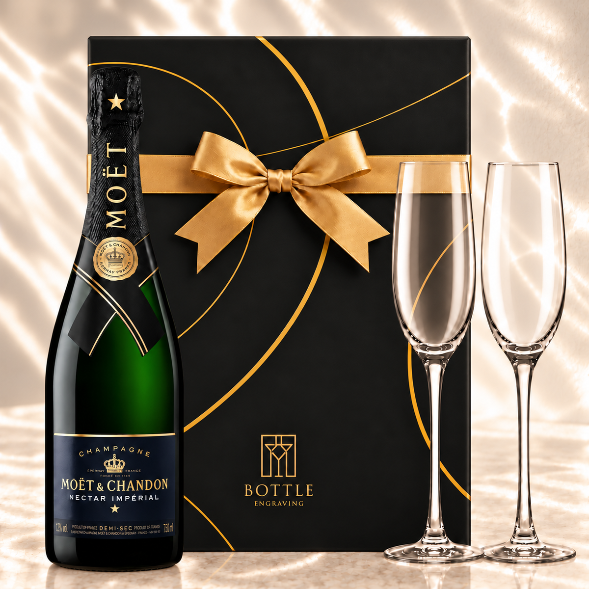 Moët & Chandon Nectar Impérial Champagne gift set with two champagne flutes and a black Bottle Engraving gift box tied with a gold bow.