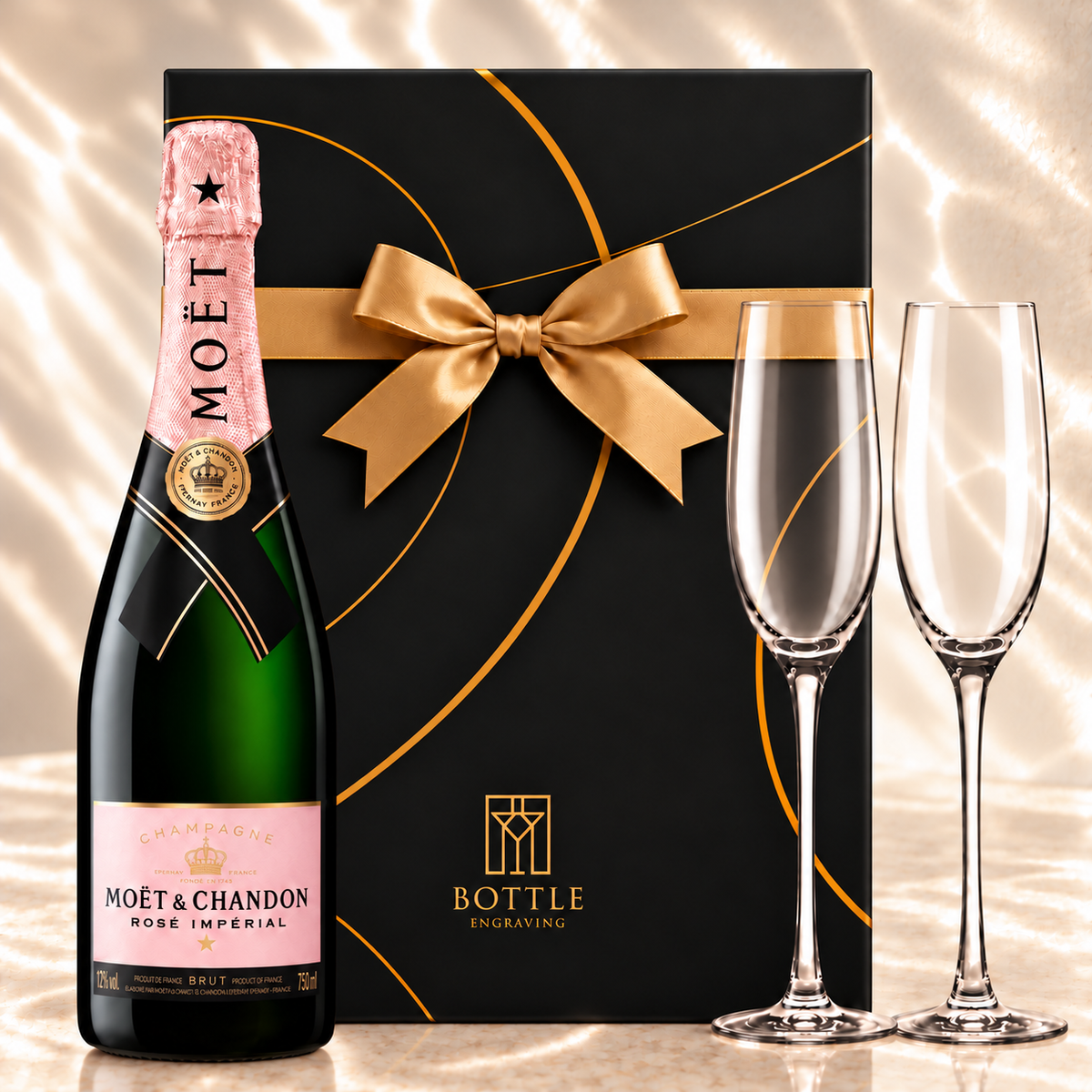 Moët & Chandon Rosé Impérial Champagne gift set with two champagne flutes and a black Bottle Engraving gift box tied with a gold bow.